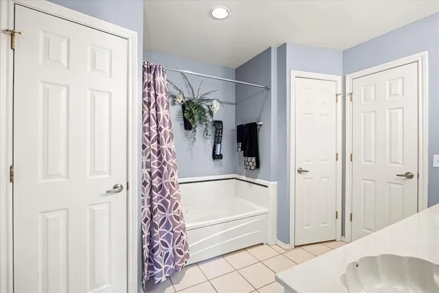 a bathroom with a bathtub and shower