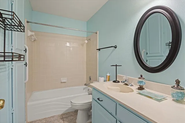 a bathroom with a granite countertop sink mirror vanity and a shower