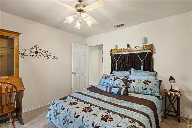 a bedroom with bed and wooden floor