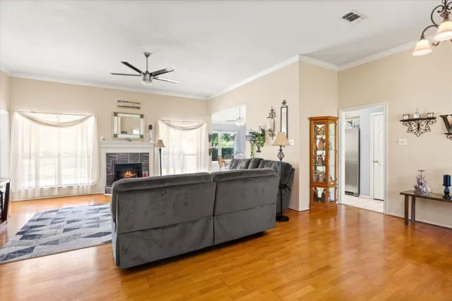 a living room with furniture a fireplace and a flat screen tv