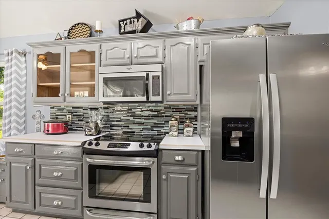 a kitchen with stainless steel appliances granite countertop a stove and a refrigerator