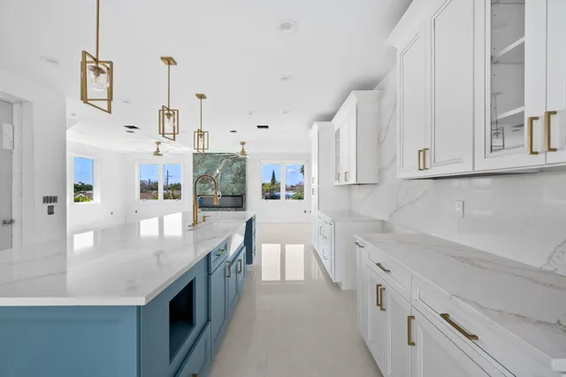 a kitchen with stainless steel appliances granite countertop a sink a stove and a refrigerator