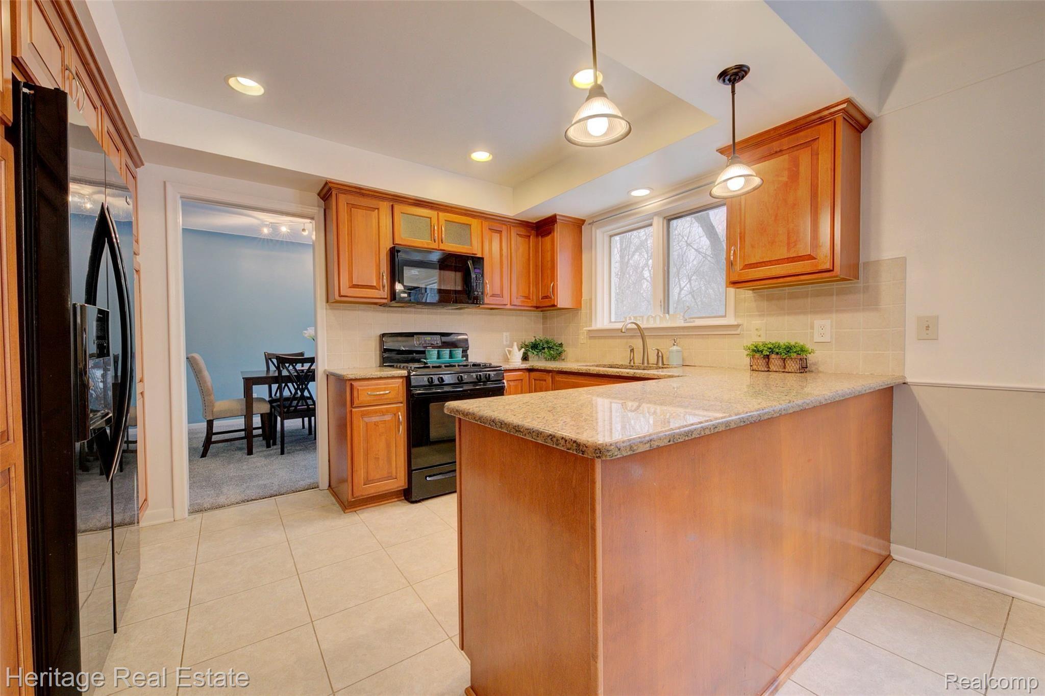 654 Old Perch Road Rochester, MI 48309 - Photo 21 of 61 This fabulous kitchen has built in pantry-cabinets, abundant cabinetry and counter top space, a desk area, and granite counter tops
