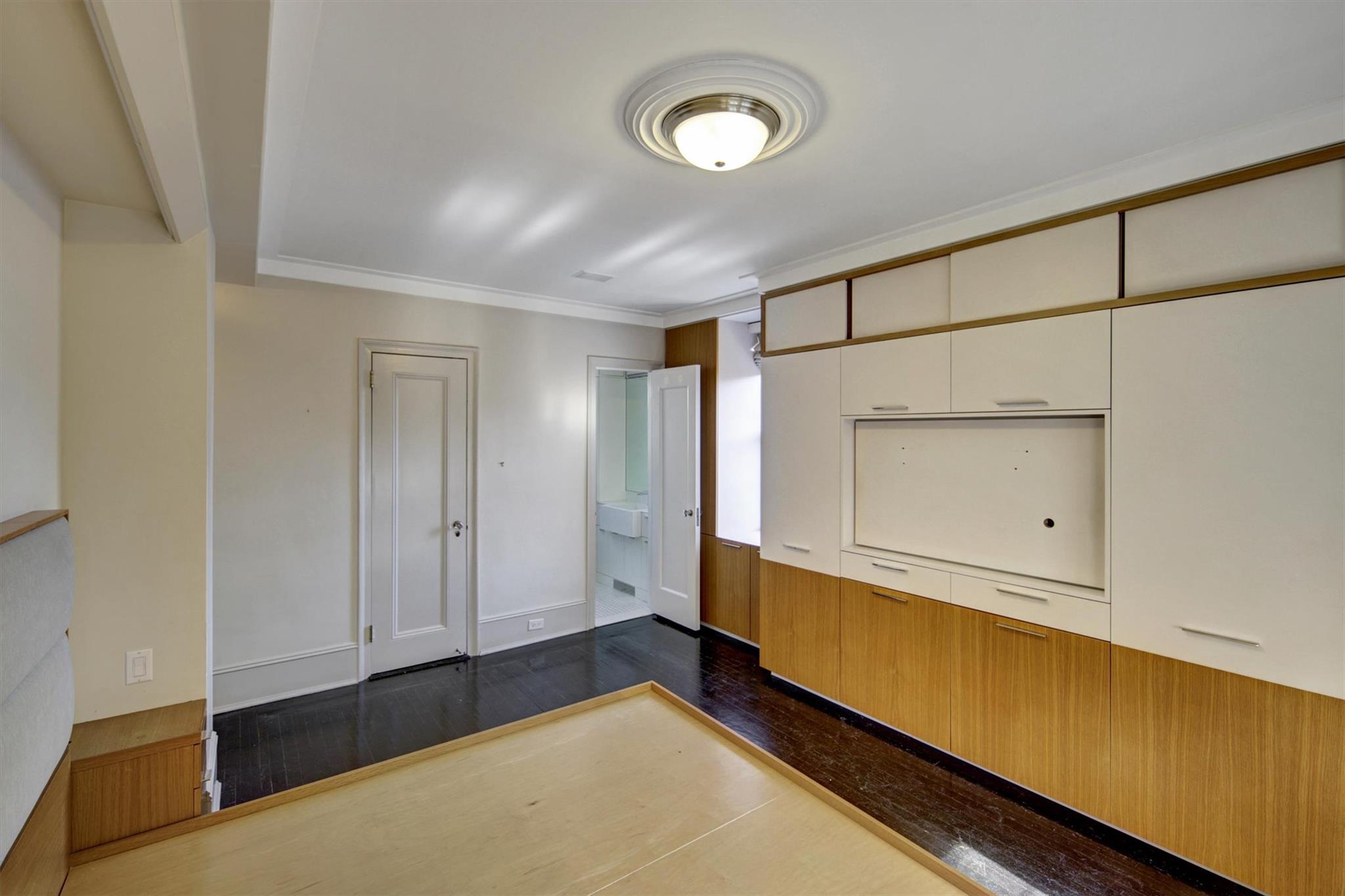 65 East 96th Street, Unit 16B Manhattan, NY 10128 - Photo 24 of 45 Unfurnished bedroom with crown molding and dark hardwood / wood-style flooring