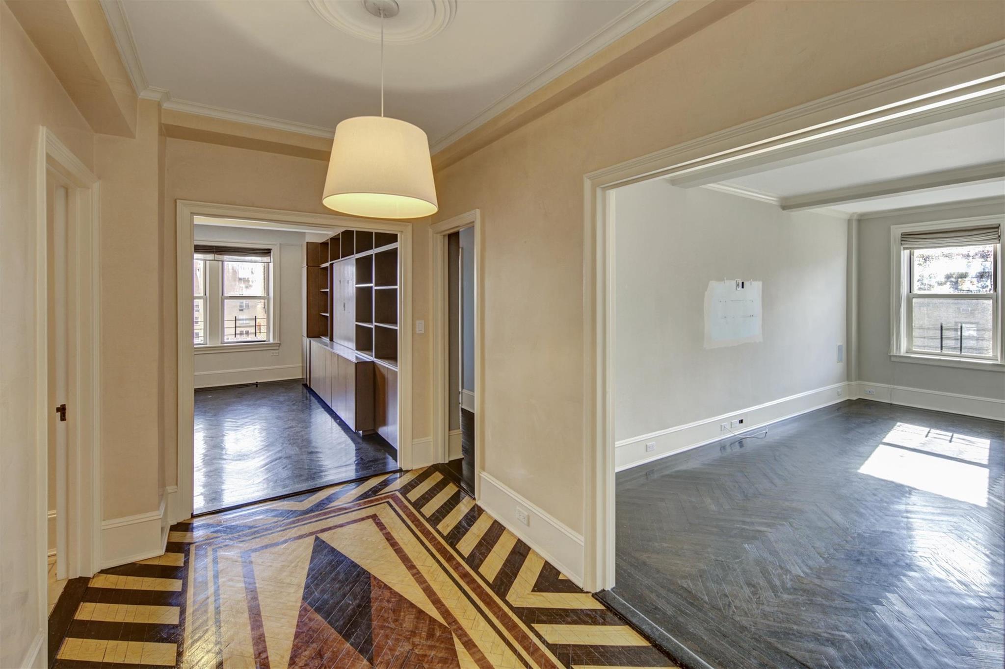 65 East 96th Street, Unit 16B Manhattan, NY 10128 - Photo 4 of 45 Corridor with crown molding, a healthy amount of sunlight, and dark parquet flooring