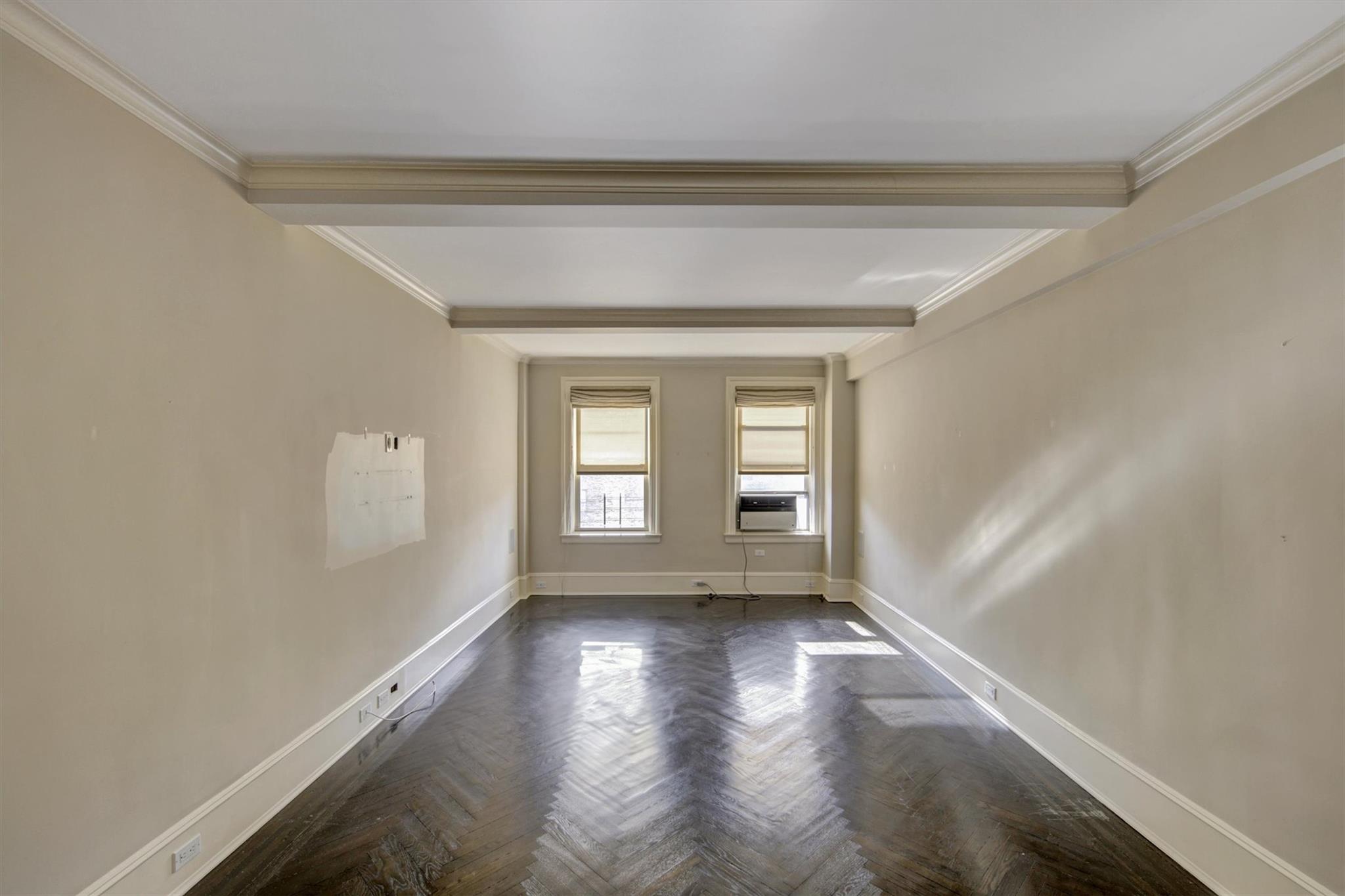 65 East 96th Street, Unit 16B Manhattan, NY 10128 - Photo 6 of 45 Unfurnished room featuring cooling unit, ornamental molding, and dark parquet floors