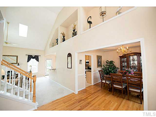 672 Seastone Street Raleigh, NC 27603 - Photo 2 of 23 Two-story vaulted foyer with hardwoods opens into the family room and has decorative alcoves for display.