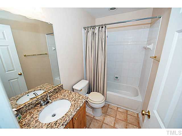 672 Seastone Street Raleigh, NC 27603 - Photo 17 of 23 Secondary bathroom with granite vanity and tile flooring.