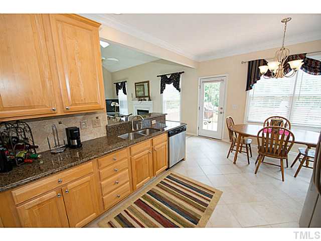 672 Seastone Street Raleigh, NC 27603 - Photo 8 of 23 A view of the breakfast room from the kitchen. Kitchen and breakfast room open up to the family room.