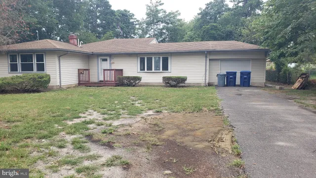 a front view of a house with yard patio and green space