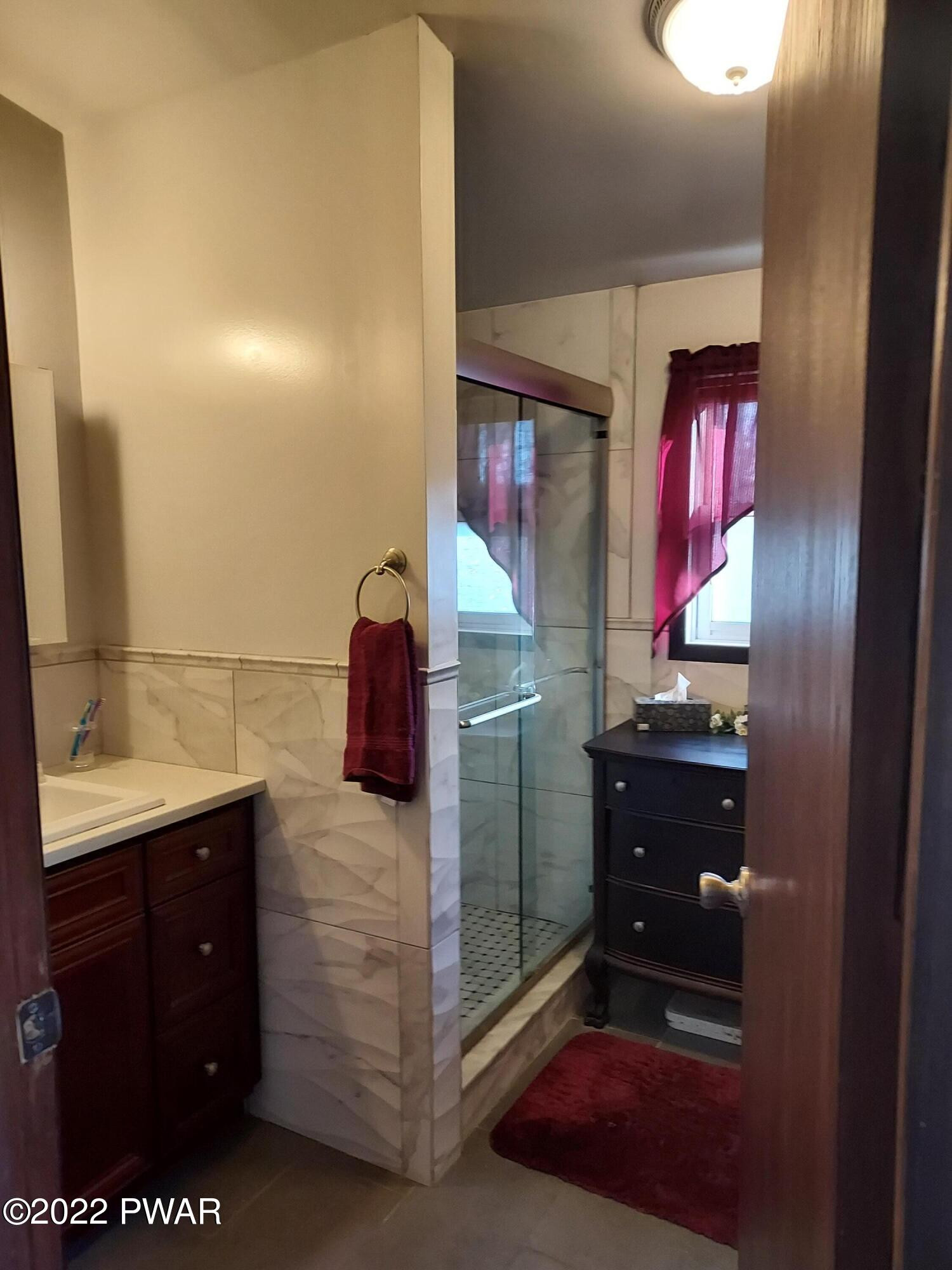 111 Rodeo Lane Hawley, PA 18428 - Photo 16 of 23 a bathroom with a sink vanity and a mirror
