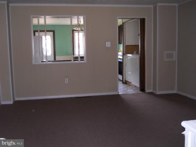 8186 Mid Haven Road Dundalk, MD 21222 - Photo 18 of 21 an empty room with mirror and fan