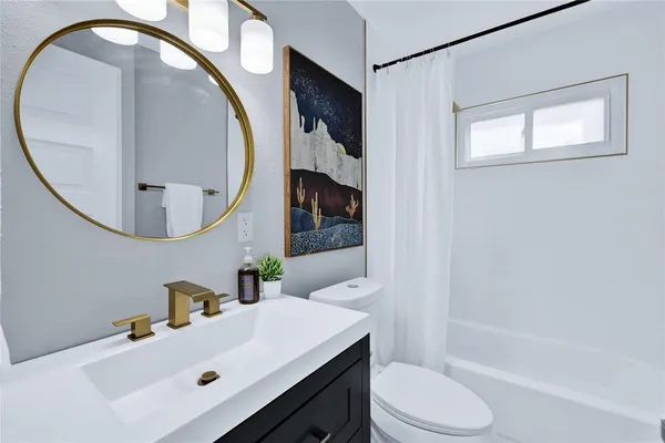 a bathroom with a sink toilet and a mirror