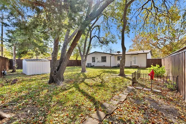a front view of a house with a yard and table and chairs