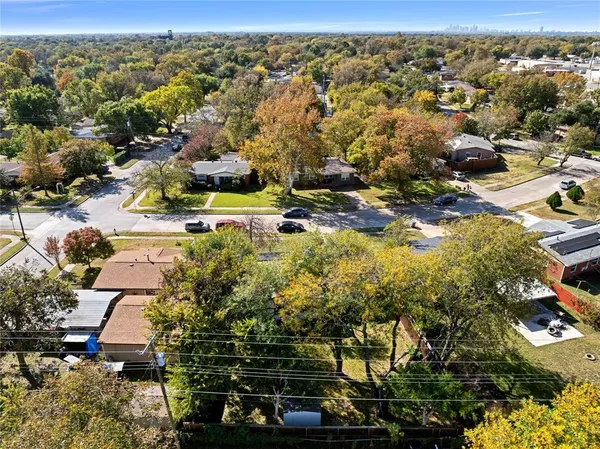 an aerial view of residential houses with outdoor space