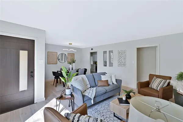 a living room with furniture and wooden floor