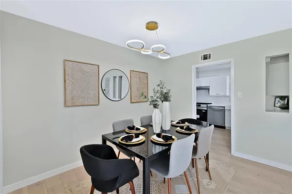 a dining room with furniture and a mirror