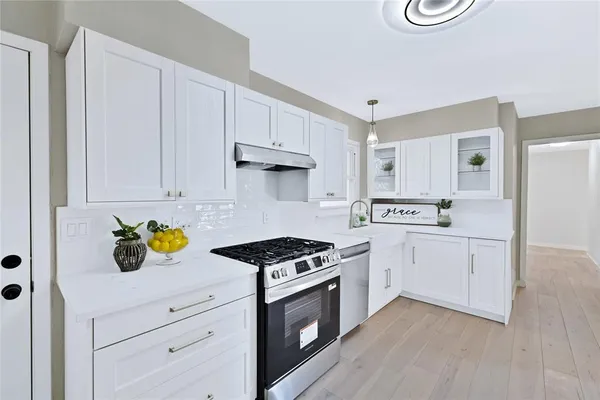 a kitchen with cabinets and appliances