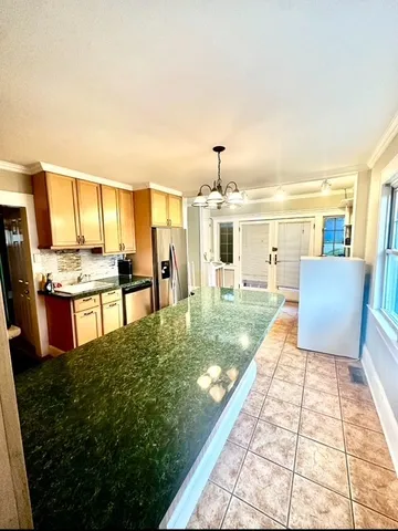 a view of kitchen with table and chairs