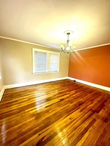 a view of a room with wooden floor and fan