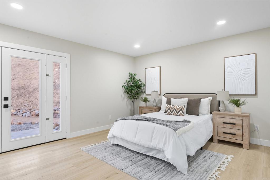 24350 Watt Road Ramona, CA 92065 - Photo 13 of 26 a bedroom with a large bed and a potted plant