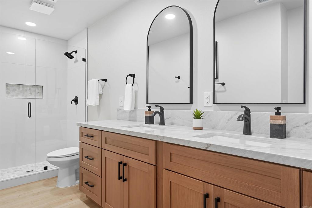 24350 Watt Road Ramona, CA 92065 - Photo 14 of 26 a spacious bathroom with a granite countertop sink a toilet and a mirror