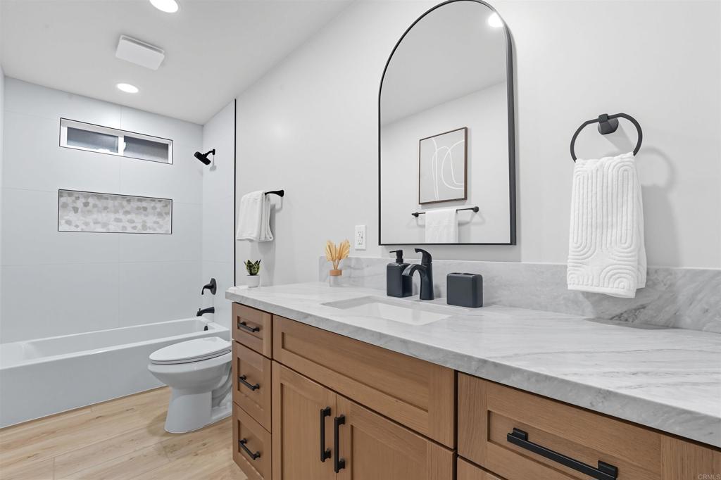 24350 Watt Road Ramona, CA 92065 - Photo 15 of 26 a bathroom with a granite countertop toilet a sink and a mirror