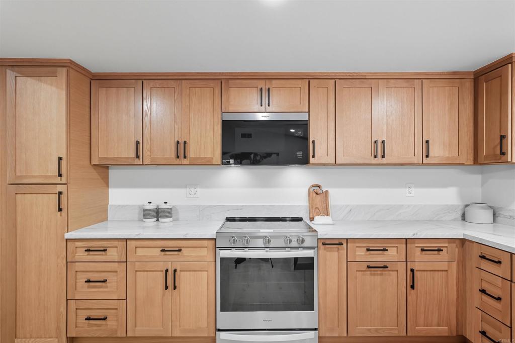 24350 Watt Road Ramona, CA 92065 - Photo 20 of 26 a kitchen with granite countertop white cabinets and white appliances