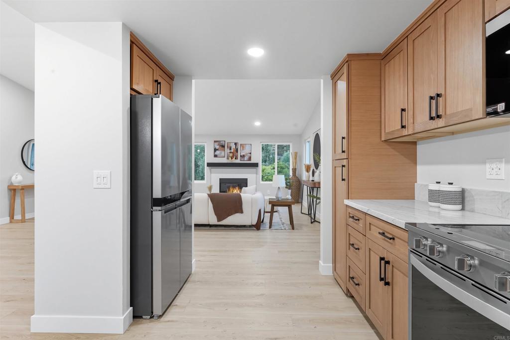 24350 Watt Road Ramona, CA 92065 - Photo 21 of 26 a kitchen with stainless steel appliances granite countertop a refrigerator and a stove top oven