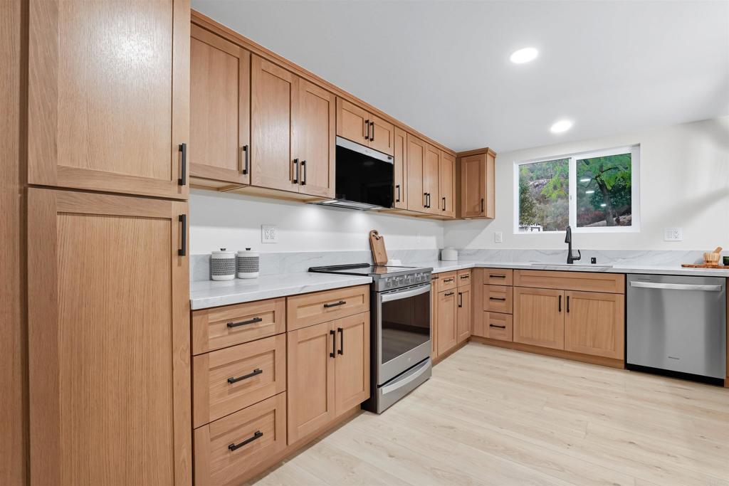 24350 Watt Road Ramona, CA 92065 - Photo 5 of 26 a kitchen with granite countertop a sink stainless steel appliances and cabinets