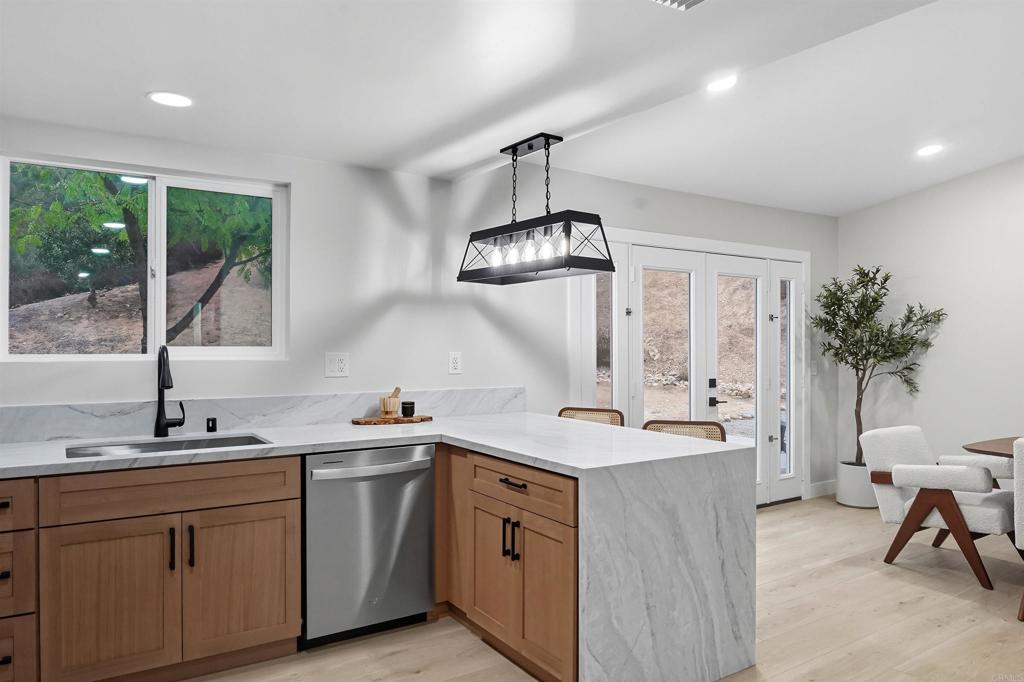 24350 Watt Road Ramona, CA 92065 - Photo 6 of 26 a kitchen with a sink a counter space appliances and cabinets