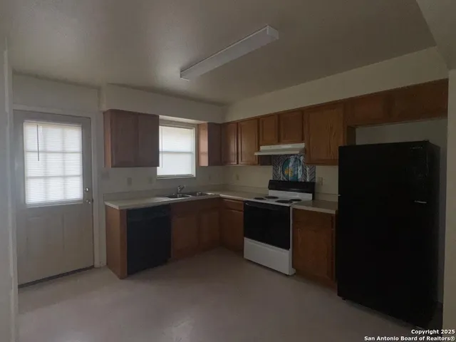 a kitchen with granite countertop stainless steel appliances and cabinets