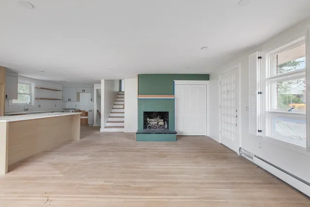 a view of a kitchen and an empty room