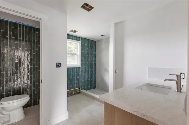 a bathroom with a sink toilet and shower