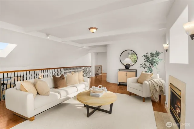 a living room with furniture a fireplace and a large window