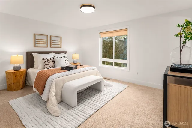 a bedroom with a bed and a potted plant