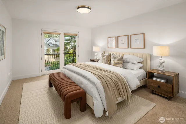 a bedroom with a bed and a large window