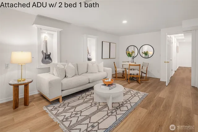 a living room with furniture a clock and a table