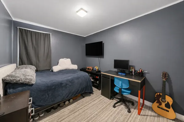 a bedroom with a workspace