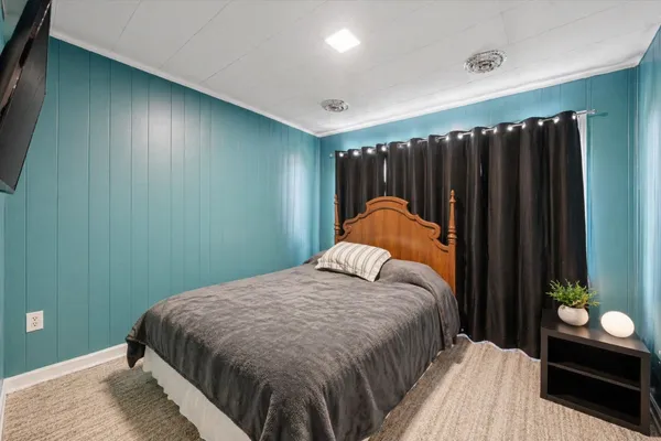 a bedroom with a bed and a dresser