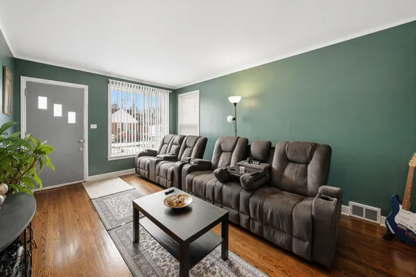 a living room with furniture and wooden floor