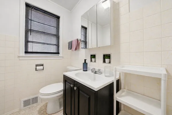 a bathroom with a sink toilet and mirror
