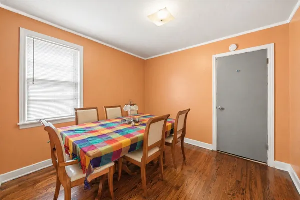 a dining room with furniture and wooden floor