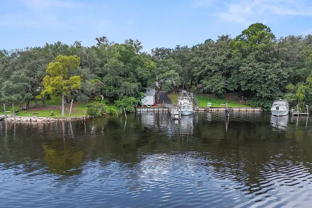 a view of house with swimming pool and lake view
