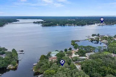 an aerial view of a house with a yard and lake view