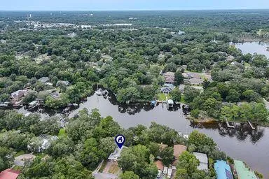 a front view of house with yard and trees in the background