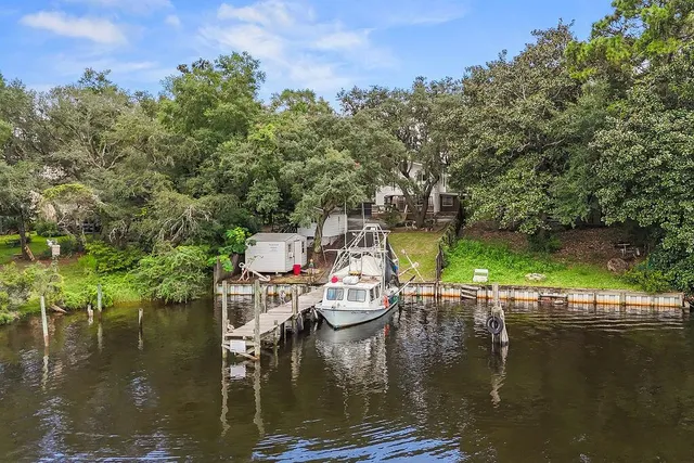 a view of a street with a barn