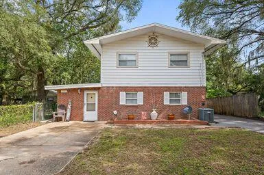 a view of backyard with wooden fence and a bench