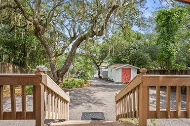 a kitchen with stainless steel appliances granite countertop a refrigerator a stove top oven a sink dishwasher and white cabinets with wooden floor