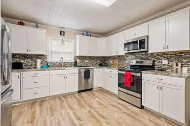 a bedroom with a bed dresser and a window